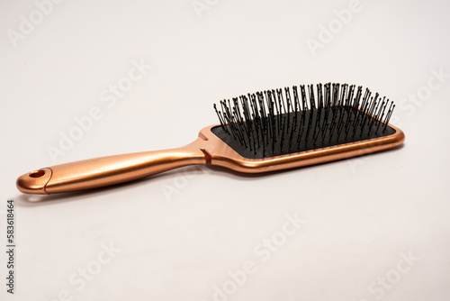 A red hairbrush isolated on a white background. Hair tools.