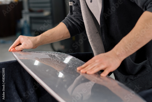 Preparation of a car spoiler for gluing a paint protection film that protects the paint from scratches and stones auto detailing