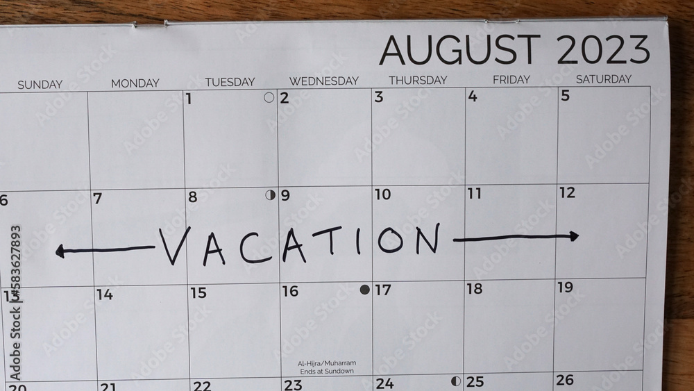 Fototapeta premium Summer vacation written on an August 2023 calendar.