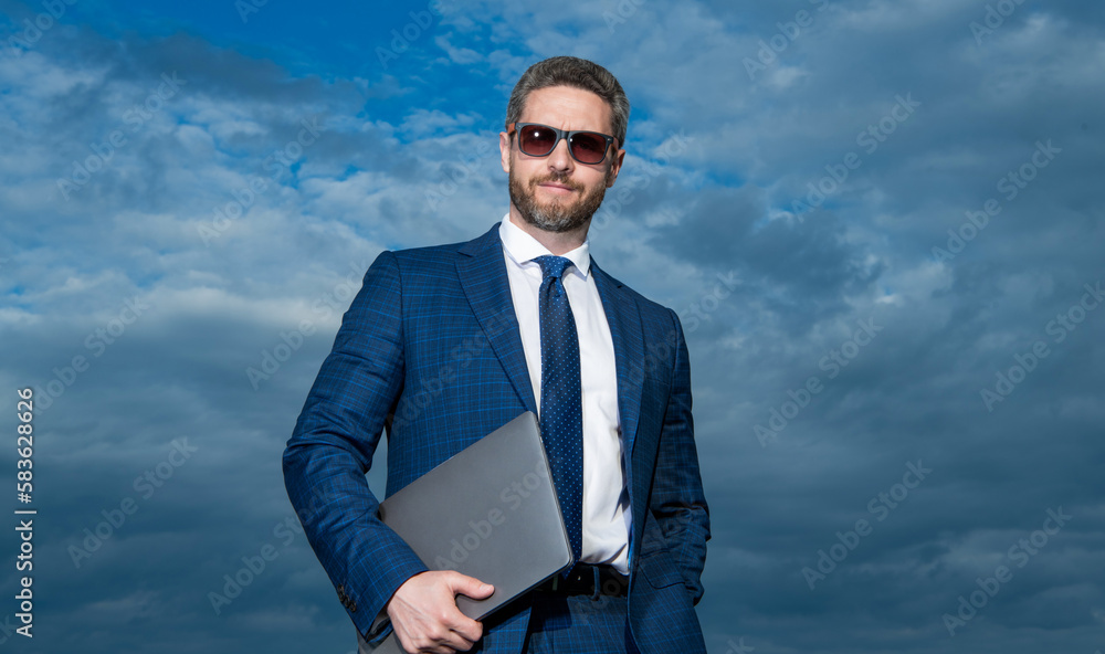 businessman with laptop on sky background. businessman with laptop outdoor businessman with laptop on sky background. businessman with laptop outdoor