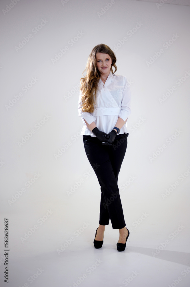 Chef hands. Kitchen hygiene. Woman wearing black latex gloves isolated on light copy space background. Professional culinary. Master class. female chef in black pants and white jacket on white studio Chef hands. Kitchen hygiene. Woman wearing black latex gloves isolated on light copy space background. Professional culinary. Master class. female chef in black pants and white jacket on white studio