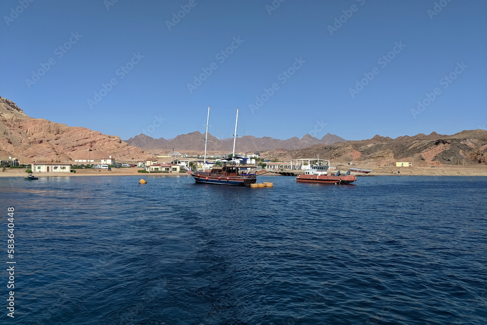 Ships near the coast of Sharm El Sheikh in Egypt. The country between the desert of the Sinai Peninsula and the Red Sea Ships near the coast of Sharm El Sheikh in Egypt. The country between the desert of the Sinai Peninsula and the Red Sea