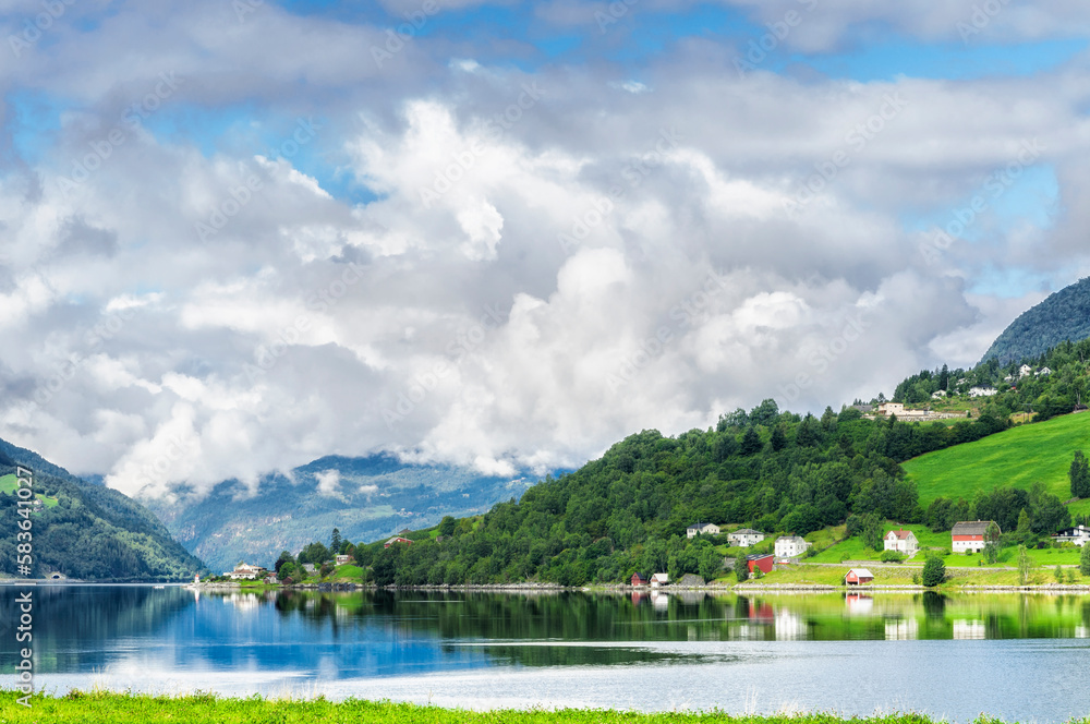 The village in the lake next to a fiord in Norway