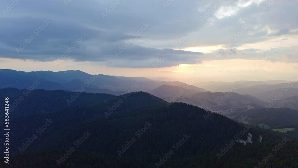 Mountain valley with mountain ranges sheltered by dark forests in Rhodope Mountains against the backdrop of sunny sky Mountain valley with mountain ranges sheltered by dark forests in Rhodope Mountains against the backdrop of sunny sky