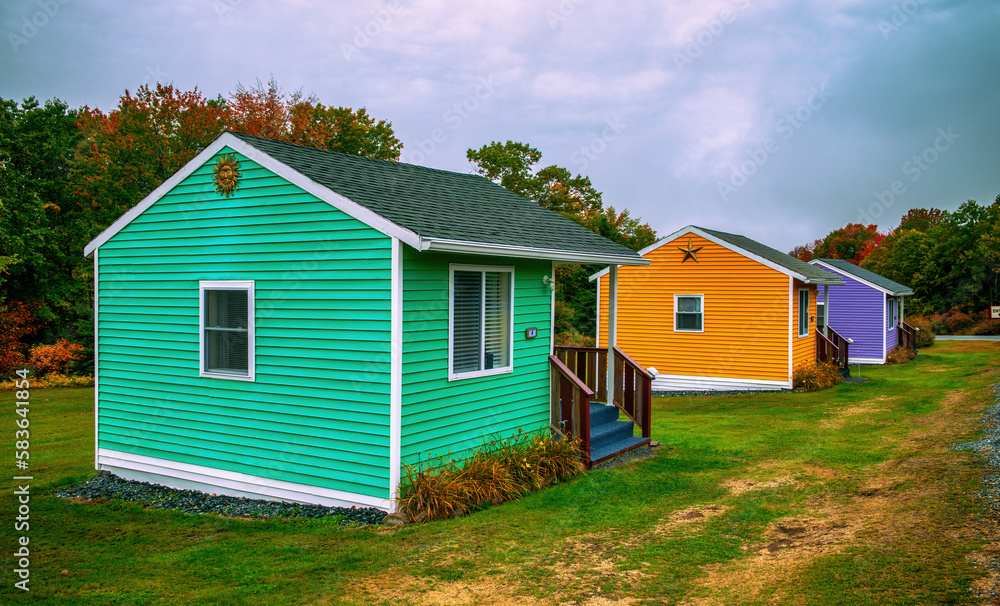 Colorful wooden homes in a foliage landscape, autumn season Colorful wooden homes in a foliage landscape, autumn season