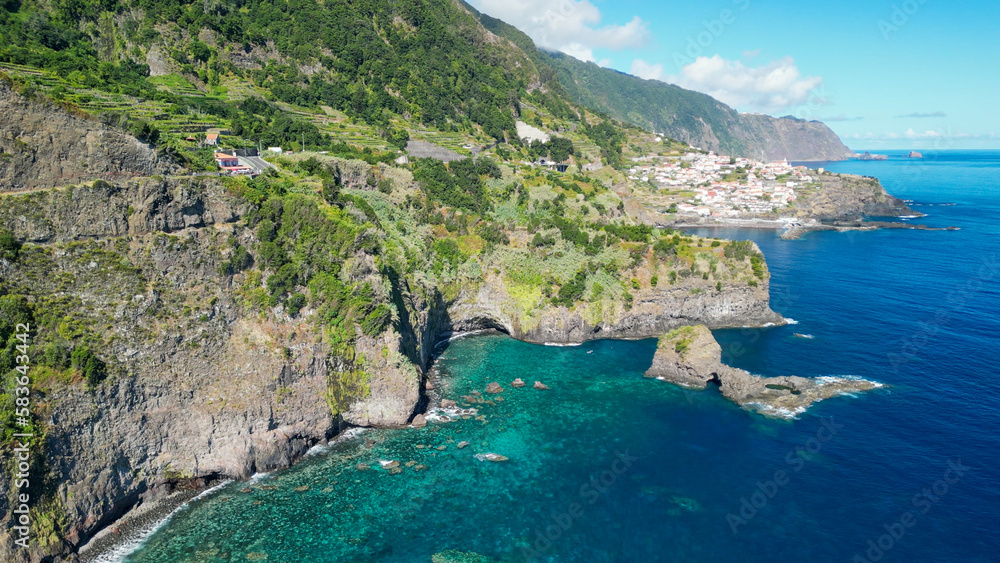 Beautiful wild coast scenery view with Bridal Veil Falls (Veu da noiva) at Ponta do Poiso in Madeira Island. Aerial view