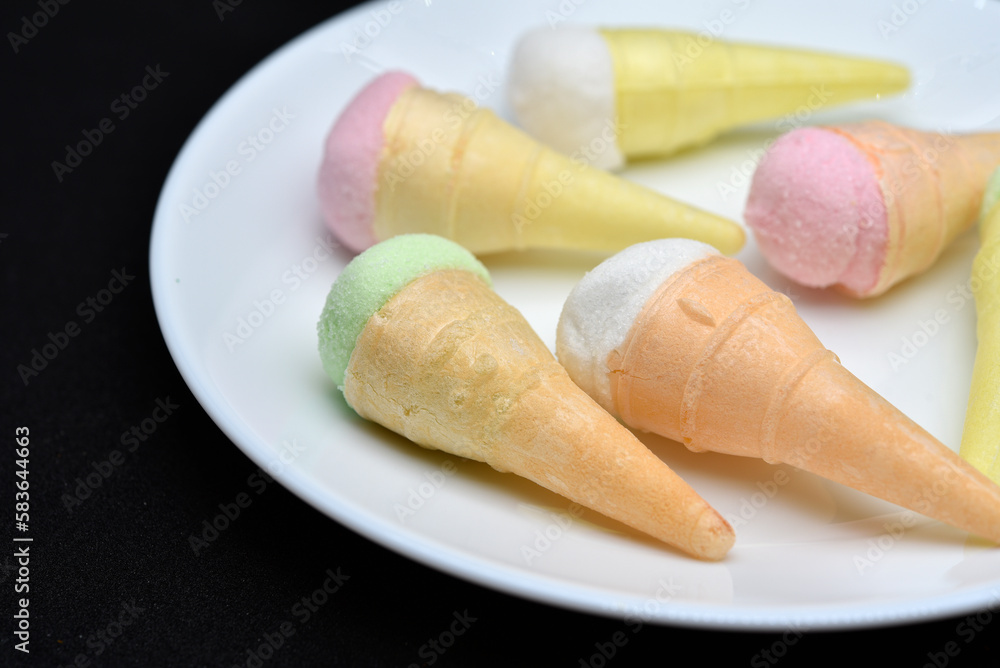 Marshmallow in the form of a sundae on a white plate. Colorful ice cream. Marshmallow in the form of a sundae on a white plate. Colorful ice cream.