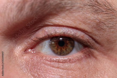 male eye with unpainted eyelashes. close-up.