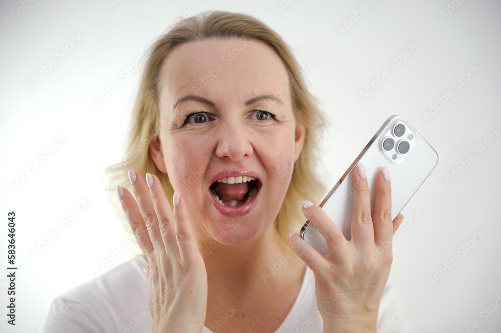 surprised woman uses a smart phone, sitting on the sofa, front view, isolated. High quality photo surprised woman uses a smart phone, sitting on the sofa, front view, isolated. High quality photo