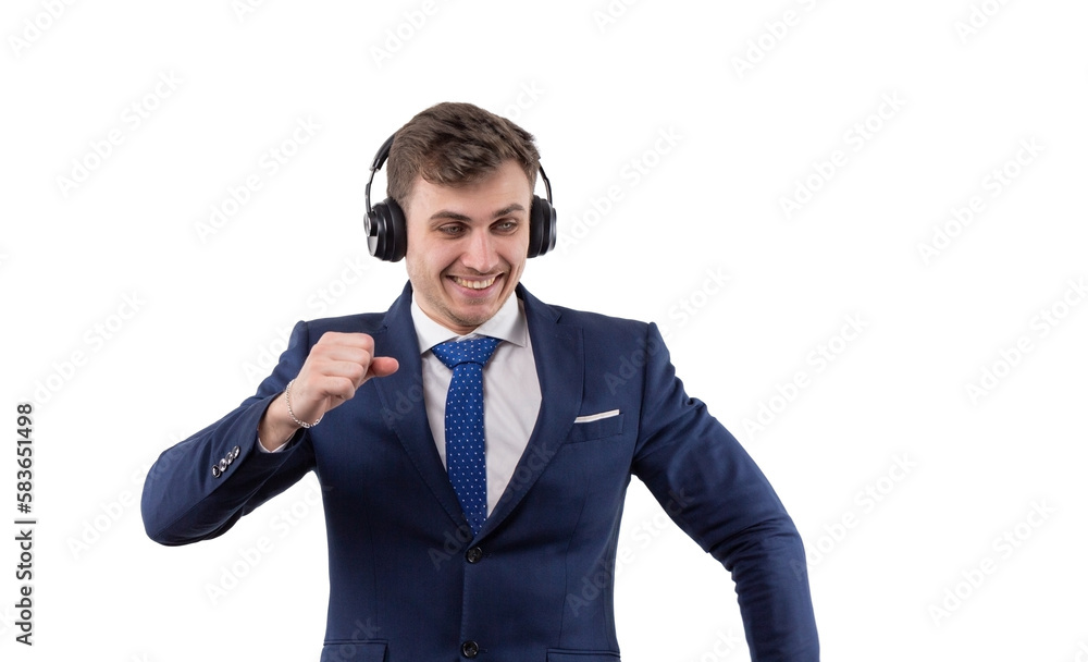 Dancing handsome man in business suit with headphones. concept of freedom in business. In studio on a white background. Dancing handsome man in business suit with headphones. concept of freedom in business. In studio on a white background.