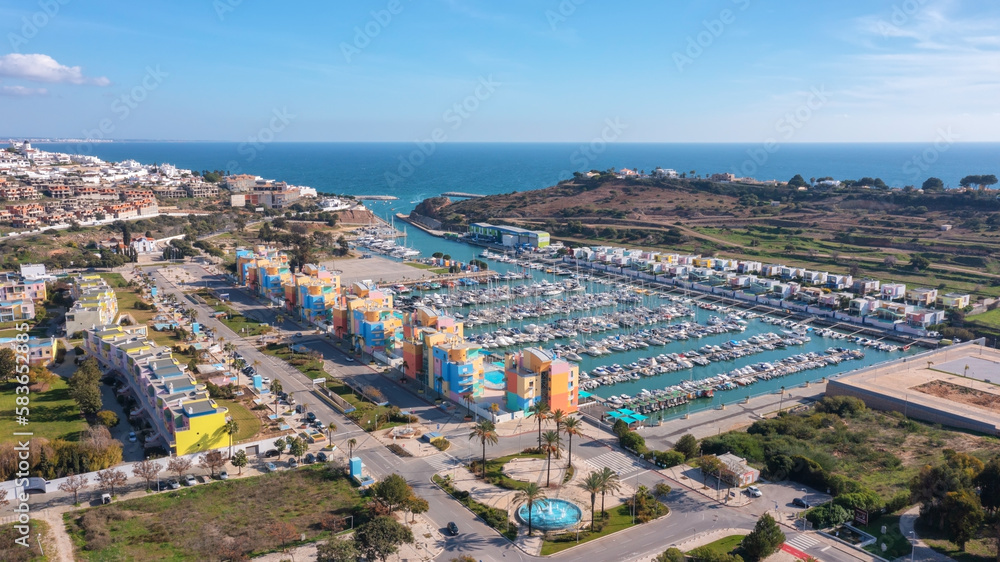 Aerial view portuguese fishing tourist town Albufuira with creative architecture. Portugal Algarve yachts on the pier