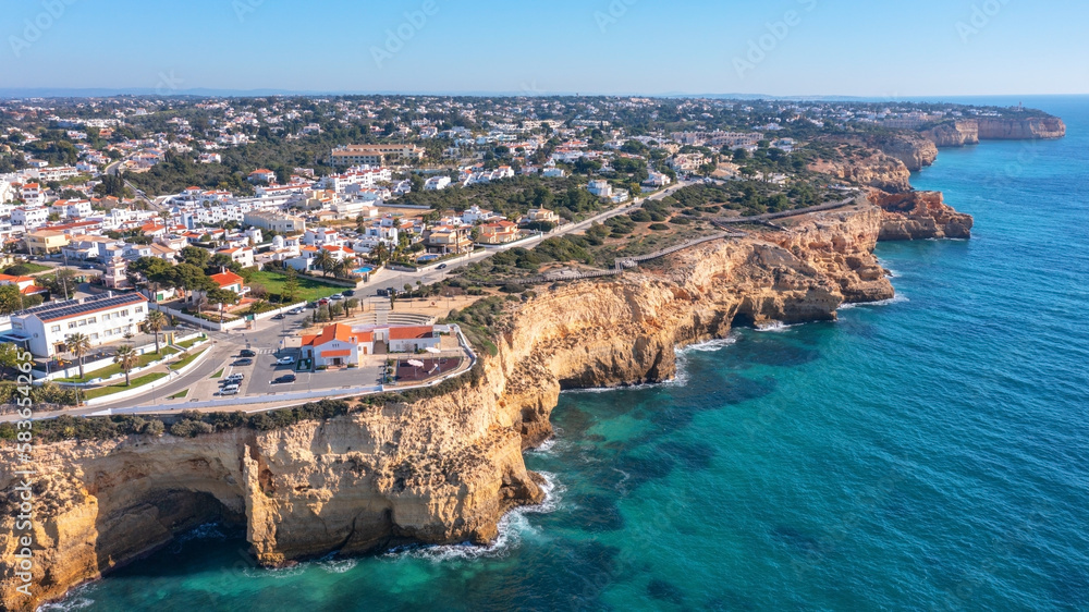 Aerial view of portuguese tourist village Carvoeiro Portugal Algarve in summer on a sunny day. wooden path over the rocks