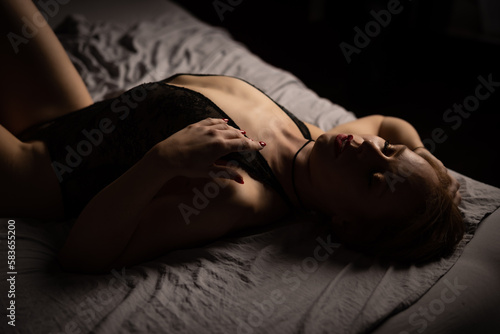 women lying on bed in black lingerie