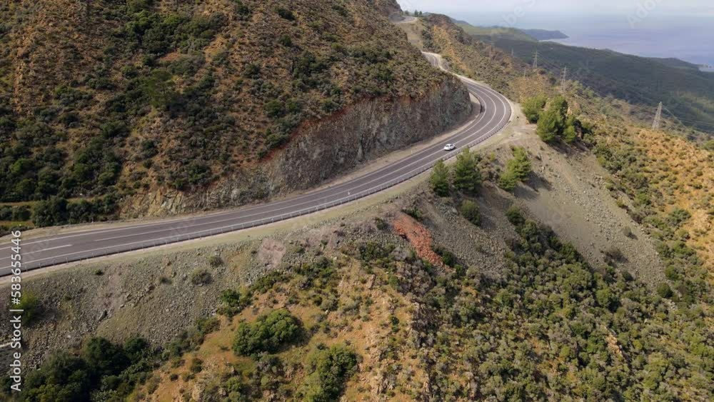 Car driving through a mountain road in Turkey during summer road trip. Aerial view Car driving through a mountain road in Turkey during summer road trip. Aerial view