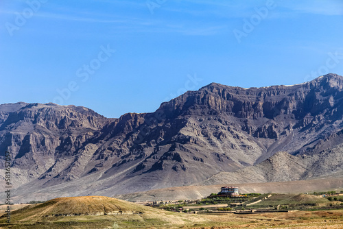 A large house and a mountain in the background