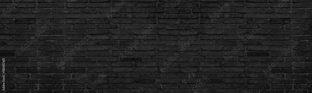 Old black brick texture. Dark aged brickwork. Gloomy grunge panoramic background