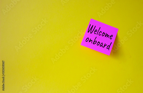 Welcome onboard symbol. Concept words Welcome onboard on pink steaky note. Beautiful yellow background. Business and Welcome onboard concept. Copy space.