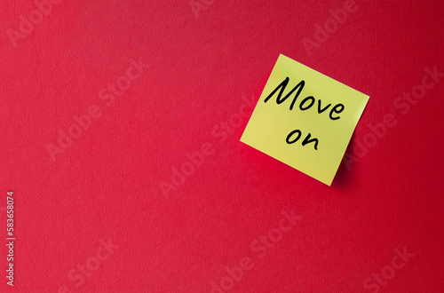 Move on symbol. Orange steaky note with words Move on. Beautiful red background. Business and Move on concept. Copy space.