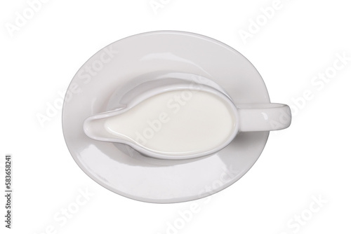 White creamer with milk on a saucer, isolated on a white background
