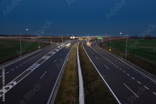 highway crossroad at night with modern street lights