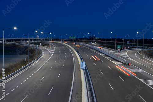 highway crossroad at night with modern street lights