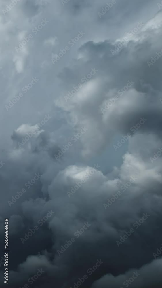 Dramatic dark storm clouds are moving fast. Vertical video Dramatic dark storm clouds are moving fast. Vertical video