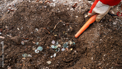 Wallpaper Mural   a treasure trove of coins found on the riverbank, a hand with a metal detector looking for coins     Torontodigital.ca