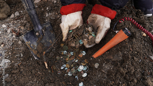 Wallpaper Mural a treasure trove of coins found on the riverbank, hands pulling out treasure trove coins Torontodigital.ca