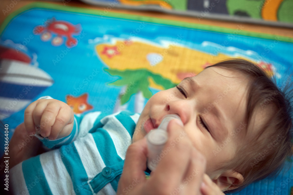 Mother nasal washing cleaning baby nose by salt water