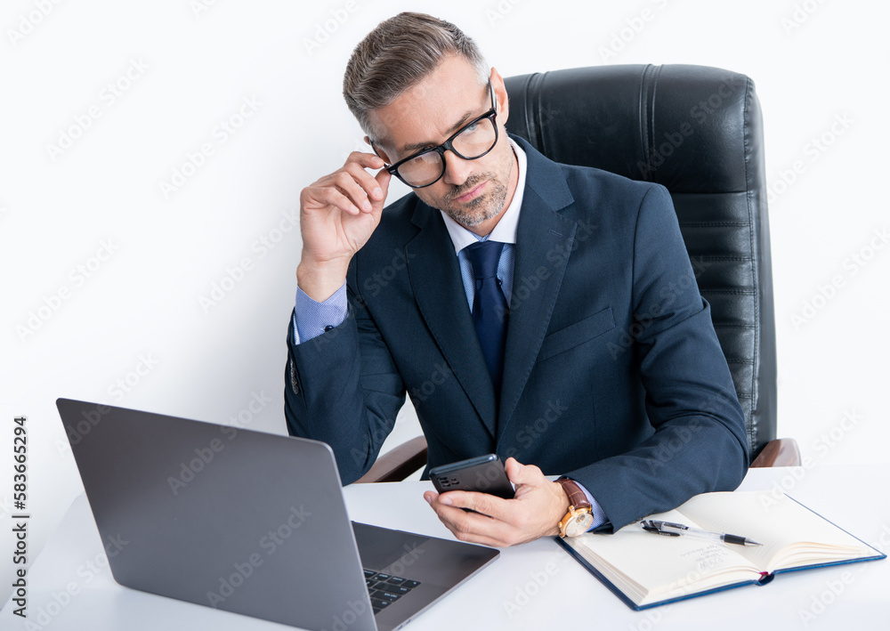 pondering busy businessman in eyewear using phone in office with computer pondering busy businessman in eyewear using phone in office with computer