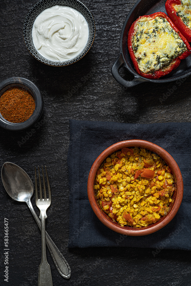 Red lentils dal and sweet pepper stuffed with cheese and spinach. Traditional spicy asian vegetarian meal. The concept of oriental food.. Red lentils dal and sweet pepper stuffed with cheese and spinach. Traditional spicy asian vegetarian meal. The concept of oriental food..