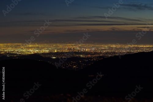 Dusk falls on Los Angeles far below us, from the Angeles Crest Highway in the San Gabriel Mountains