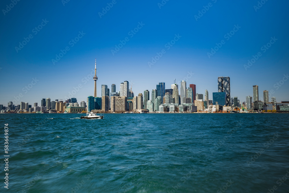 view of toronto skyline from toronto island with no clouds in the sky