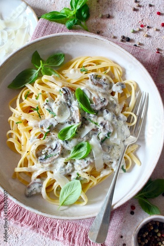 Italian pasta with mushrooms, cream sauce and parmesan cheese. Top view.