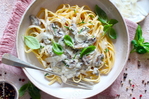 Italian pasta with mushrooms, cream sauce and parmesan cheese. Top view. photo