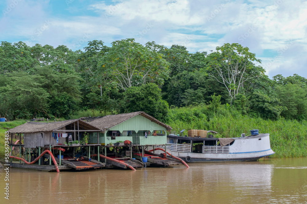 Fototapeta premium Primitive gold mining operations on the Amazon river in the Amazon rainforest in Brazil, 2023.
