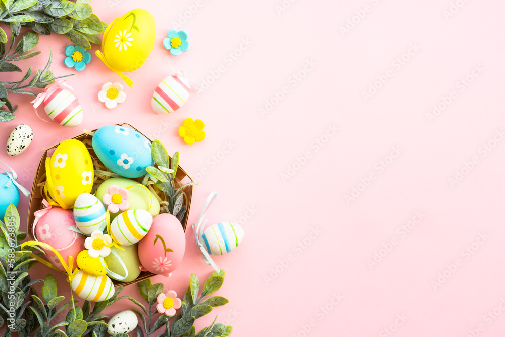 Easter eggs in the nest on pink background. Easter decor. Flat lay image with copy space.