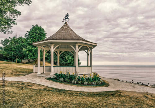 Niagara-on-the-Lake, Ontario, Canada - July 9, 2016: Gazebo st Queen's Royal Park sits under an overcast summer morning sky framed by the walking path