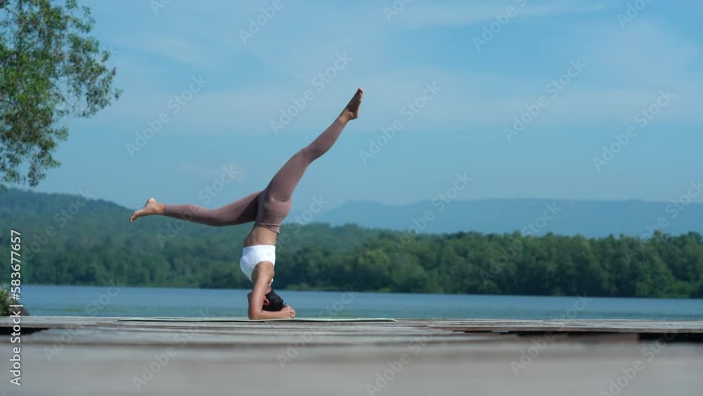 Beautiful attractive Asian woman practice fitness yoga pose on the pool above the Mountain peak in front of nature lake views, Feel so comfortable lifestyle and relax exercise in holiday morning Beautiful attractive Asian woman practice fitness yoga pose on the pool above the Mountain peak in front of nature lake views, Feel so comfortable lifestyle and relax exercise in holiday morning