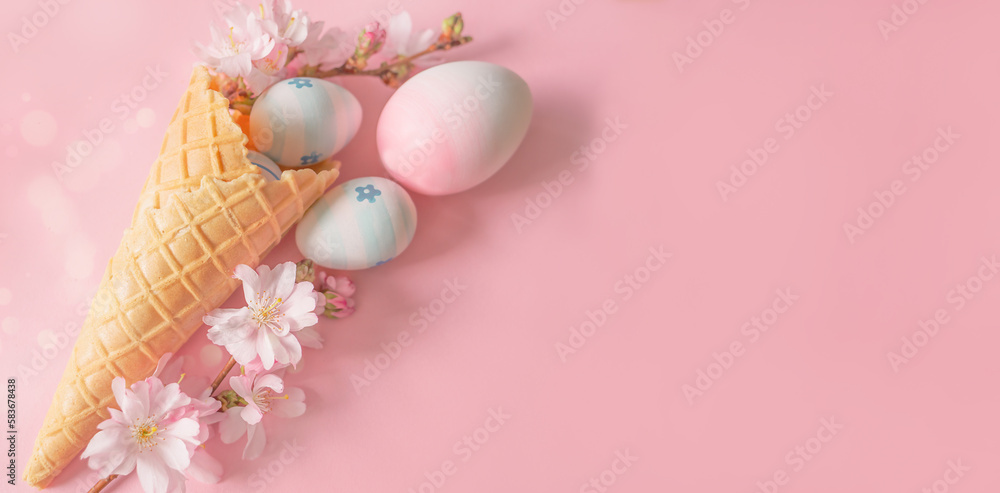 Easter eggs, cherry blossom flowers, ice cream cone on a pink background. Minimal concept Easter eggs, cherry blossom flowers, ice cream cone on a pink background. Minimal concept