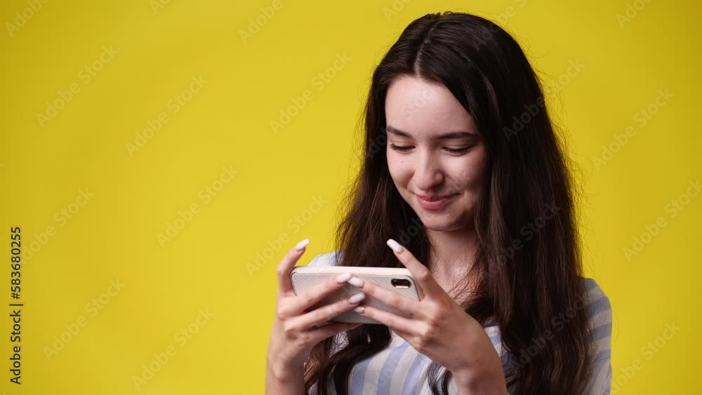 4k video of one girl sending messages on yellow background. 4k video of one girl sending messages on yellow background.