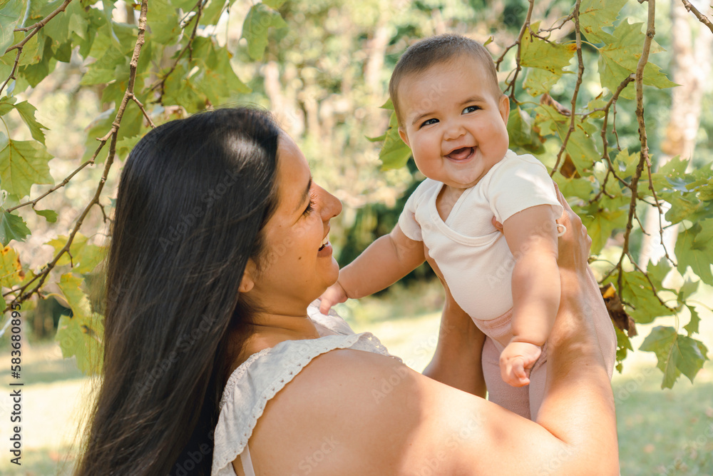 Beautiful mother plays with her child outdoor. Beautiful mother plays with her child outdoor.