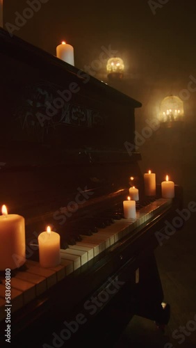 In a dark background, a witch performs a mystic rite with black candles and voodoo magic. A close-up of the piano keys intensifies the paganism and mysticism.