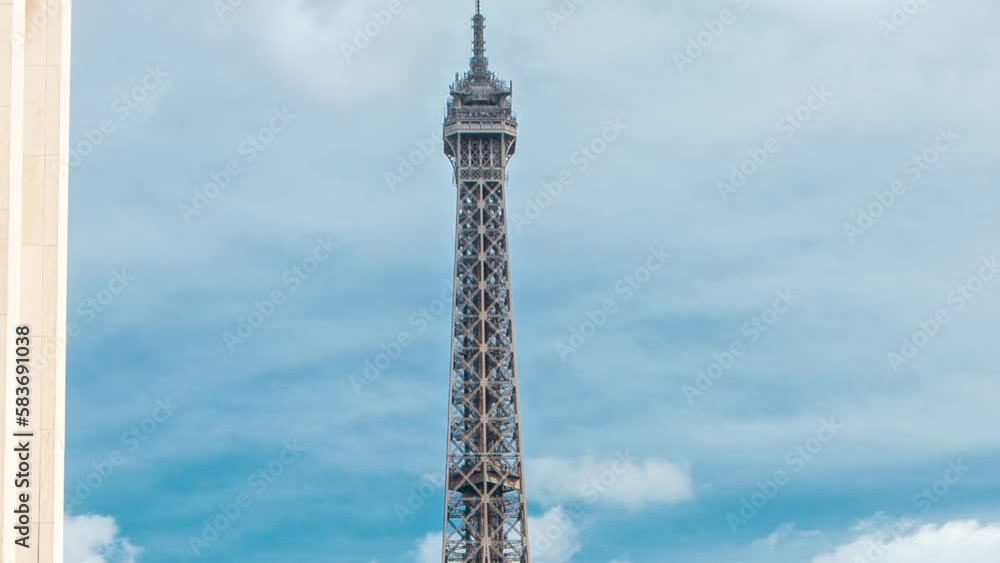 Eiffel Tower and the golden statues of women in the sun light timelapse, Trocadero square, Paris, France. Blue cloudy sky at sunny summer day Eiffel Tower and the golden statues of women in the sun light timelapse, Trocadero square, Paris, France. Blue cloudy sky at sunny summer day