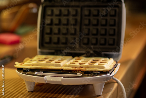 Cooking waffles stuffed with sausage, cheese. Pizza waffle, piffle.