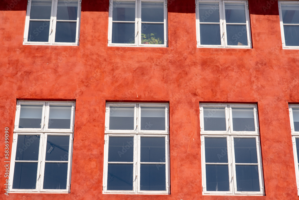 Fototapeta premium Windows in red house facade as background or texture