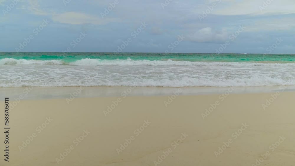 SLOW MOTION: Coastline of sea with breaking waves on sand. Ocean background with clear azure water. Beach with azure sea water. Sea shore with sandy white beach. Landscape view of beaches sea. SLOW MOTION: Coastline of sea with breaking waves on sand. Ocean background with clear azure water. Beach with azure sea water. Sea shore with sandy white beach. Landscape view of beaches sea.