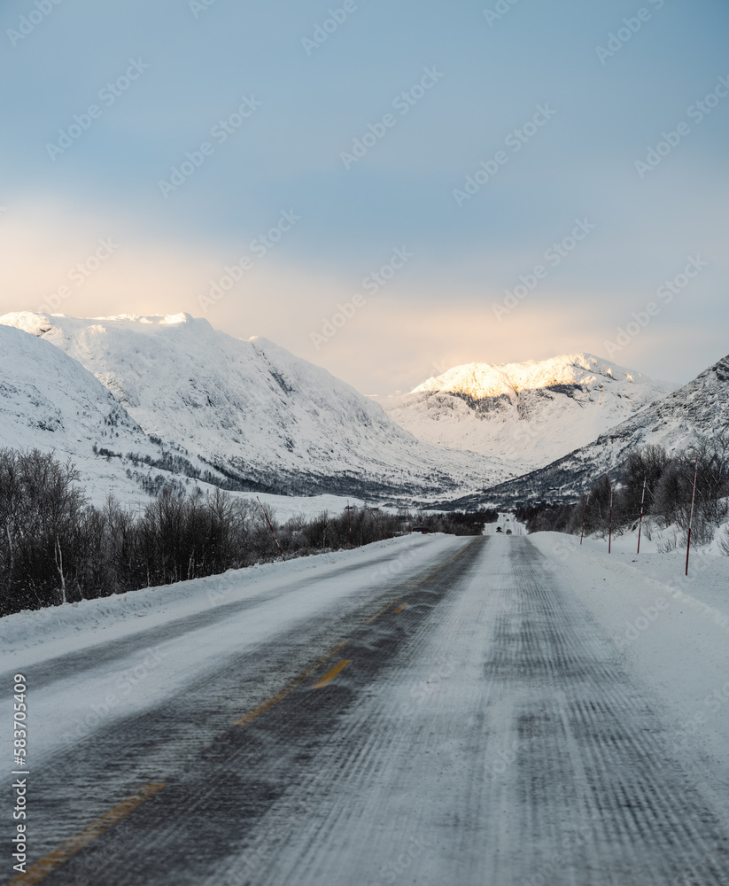 Road through the Norwegian highlands Hemsdal viken in rural Norway during winter during sunrise