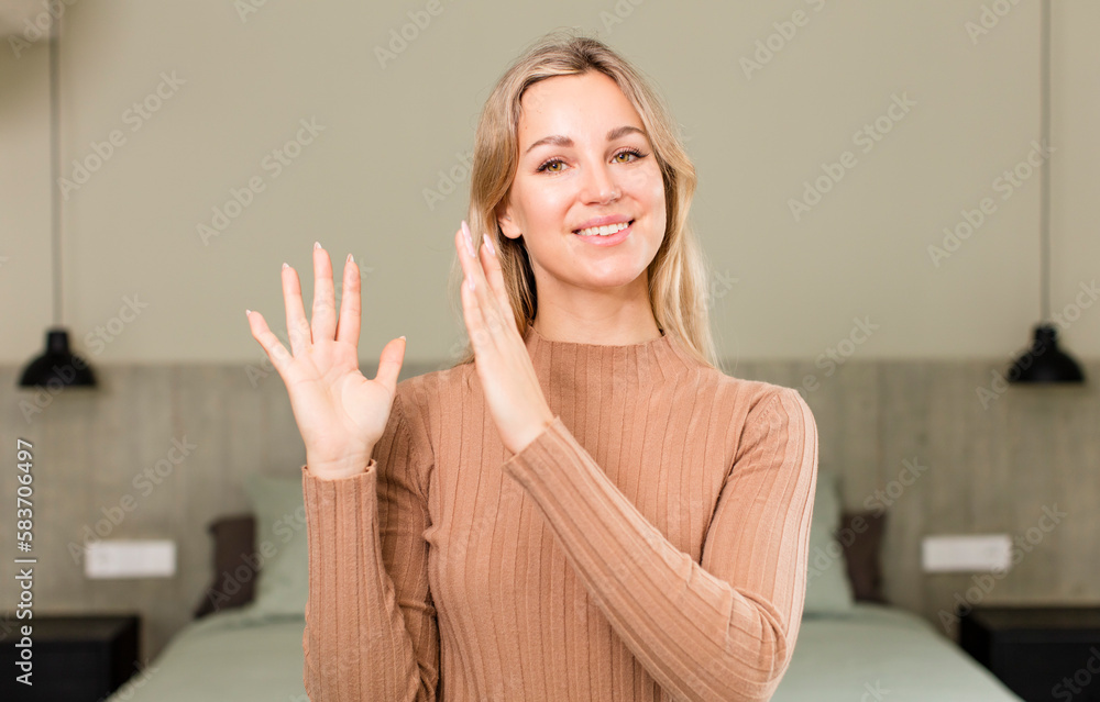 young pretty woman feeling happy and successful, smiling and clapping hands, saying congratulations with an applause. bed concept young pretty woman feeling happy and successful, smiling and clapping hands, saying congratulations with an applause. bed concept