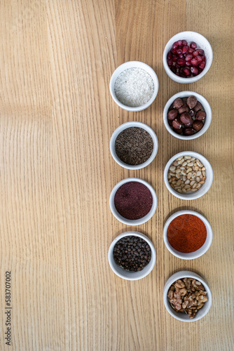 set of spices on wooden background, pomegranate, pine nut, walnut, hazelnut